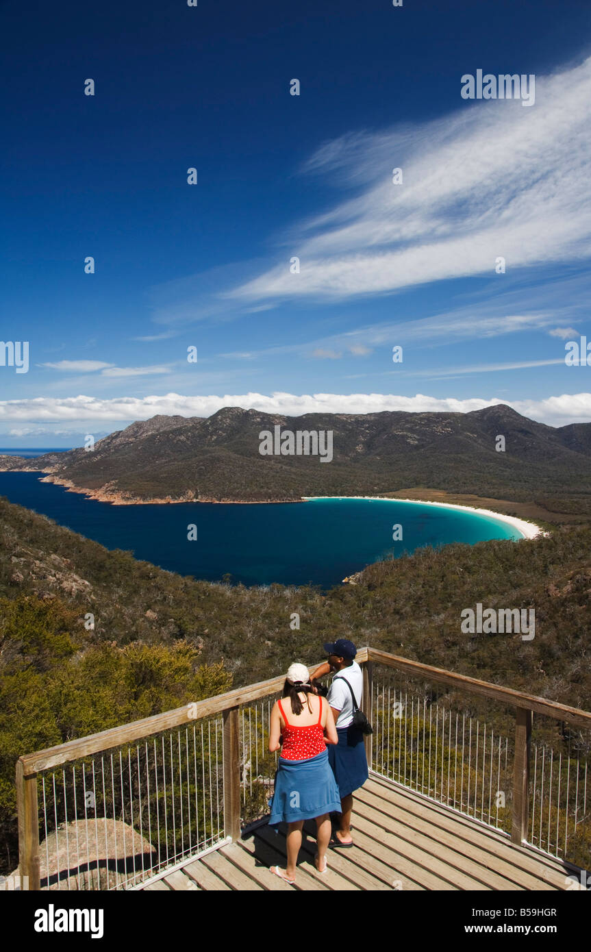 Tourists admiring the view of Wineglass Bay, Coles Bay, Freycinet Peninsula, Freycinet National Park,Tasmania, Australia Stock Photo