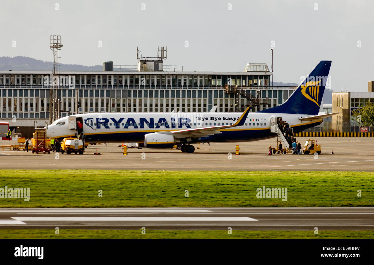 A Ryanair plane is boarded by passengers at Glasgow Prestwick International Airport, Ayrshire, Scotland. Stock Photo