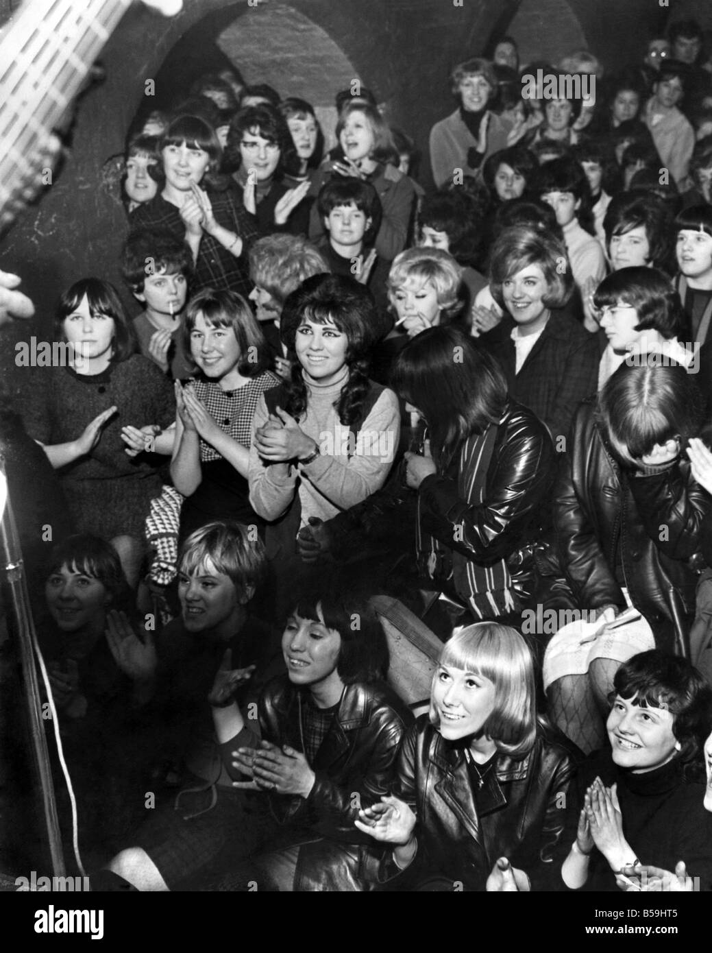 A lunchtime audience at the Cavern. Club in Liverpool. The club has been the springboard to success for many bands, the latest being a four man group called 'The Beatles' (Not performing in this image) December 1963 P008118 Stock Photo