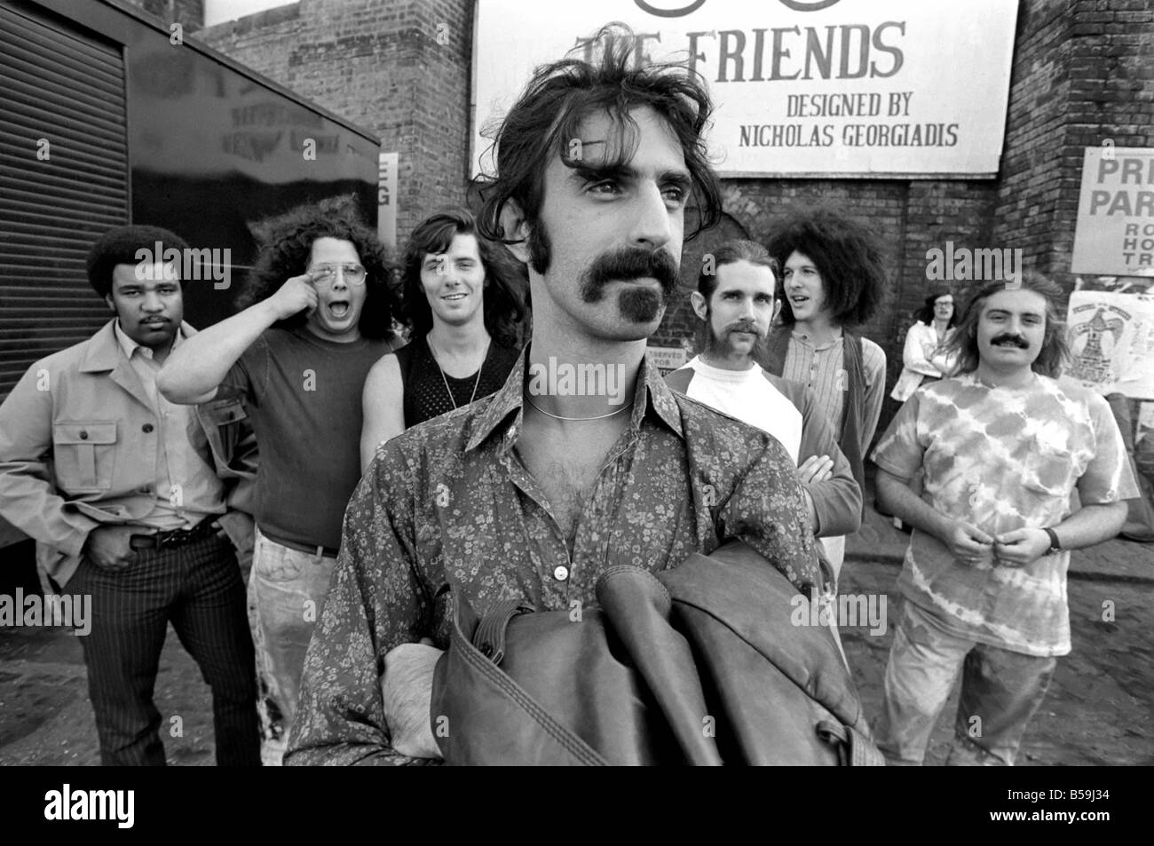 Frank Zappa. Another American rock group hits London town: Frank Zappa and his outfit the Mothers of Invention are at present on tour in the U.K. next weekend they visit the Bath Pop Festival. Yesterday Sunday they saw some of the sights of London, which included a visit to the Round House Entertainment Centre in Camden town. The boys hail from Los Angeles: Frank Zappa (foreground), George Duke, Ian Underwood, Jeff Simmons, Mark Volman, Howard Kalen and Aynsley Dunbar. June 1970 70-5893-001 Stock Photo
