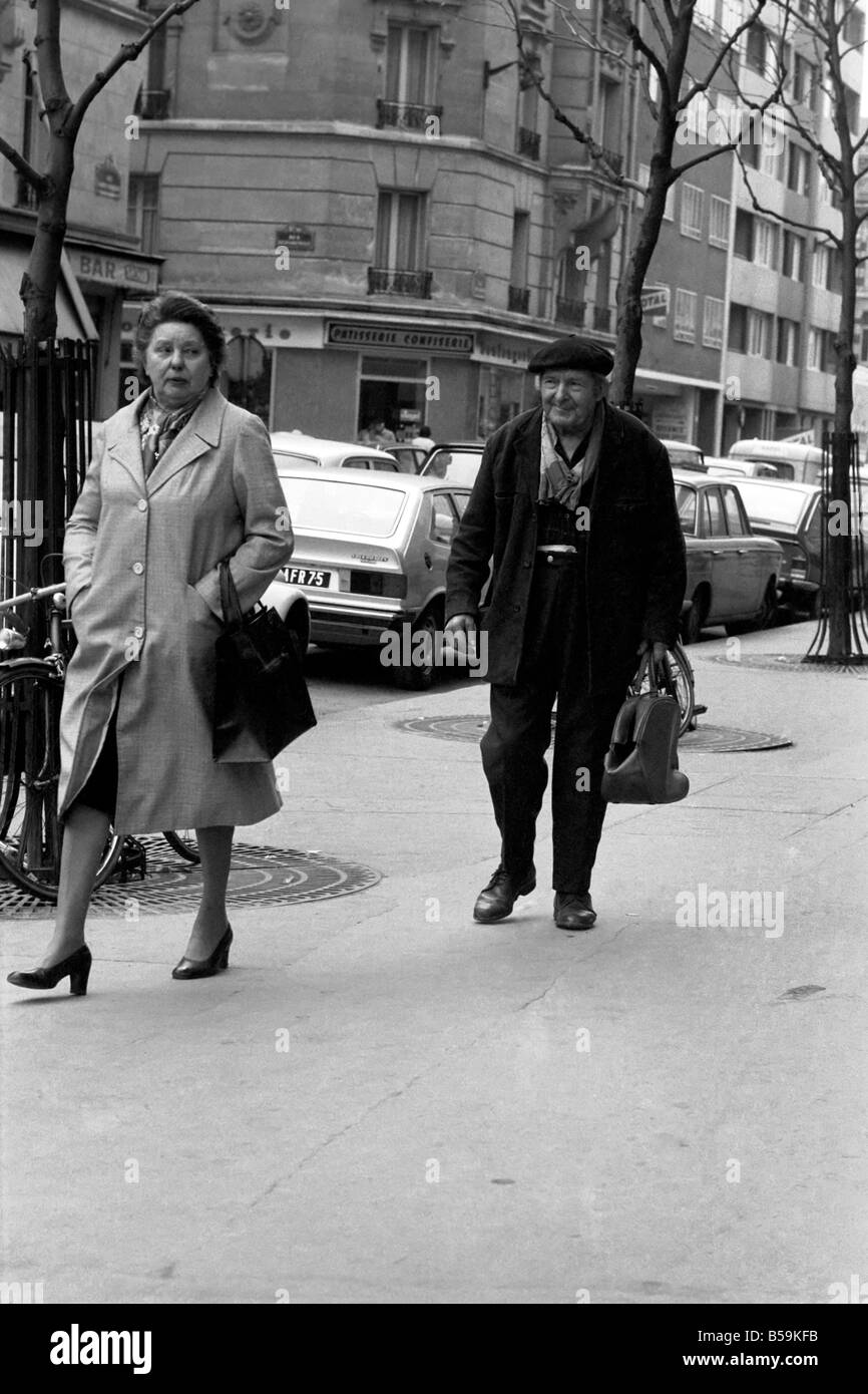 STREET パリ Man and woman walking down the street in Paris, France. April 1975