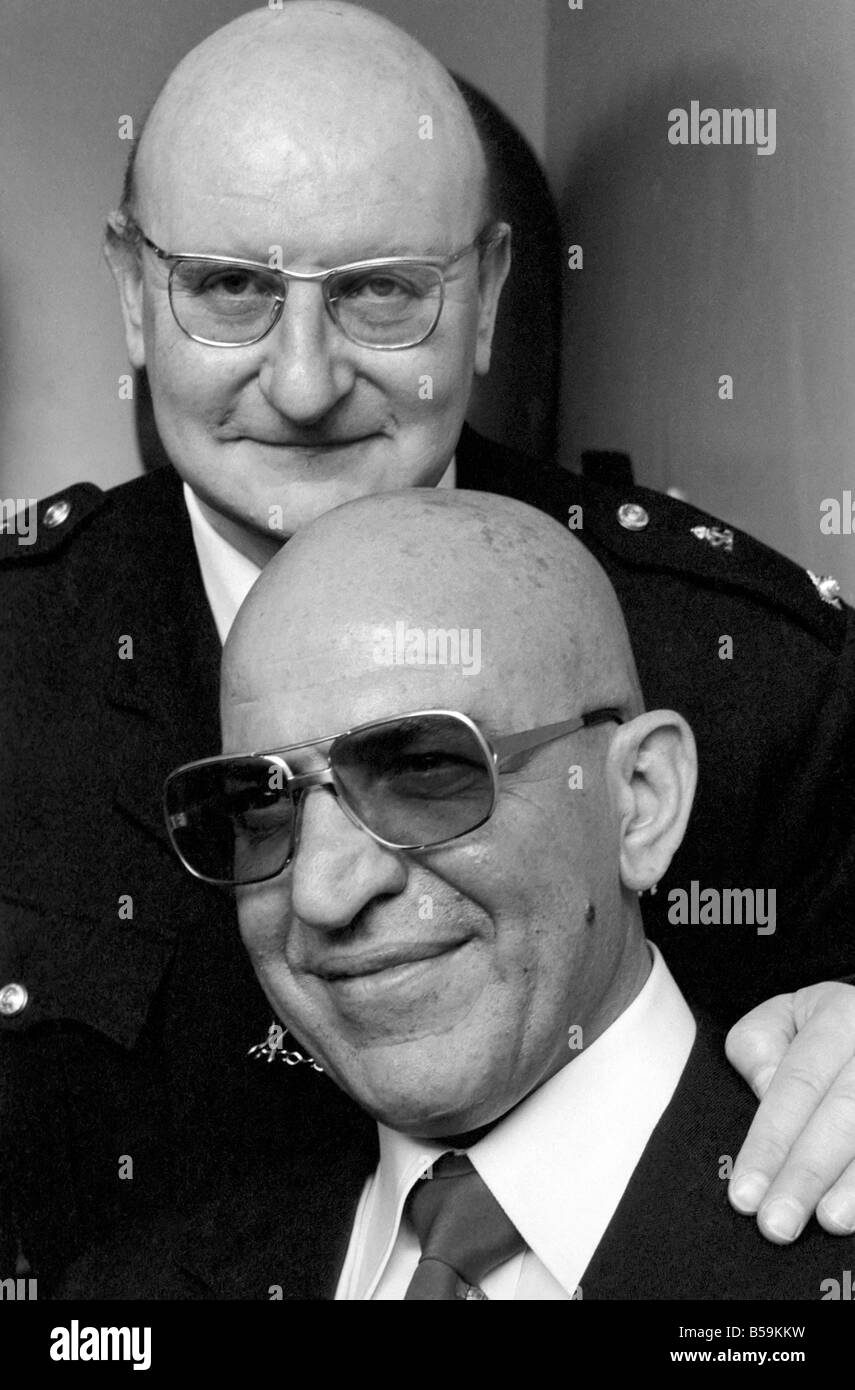 American actor Telly Savalas (bottom) who plays Kojak in the television series, pictured at Capital Radio Headquarters at Euston Tower, London, ;April 1975 ;75-2087-016 Stock Photo