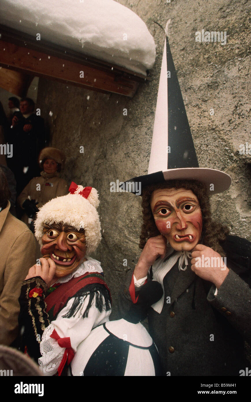 People wearing masks, one with a tall pointed hat, Fasnacht carnival, Imst, Austria, Europe Stock Photo