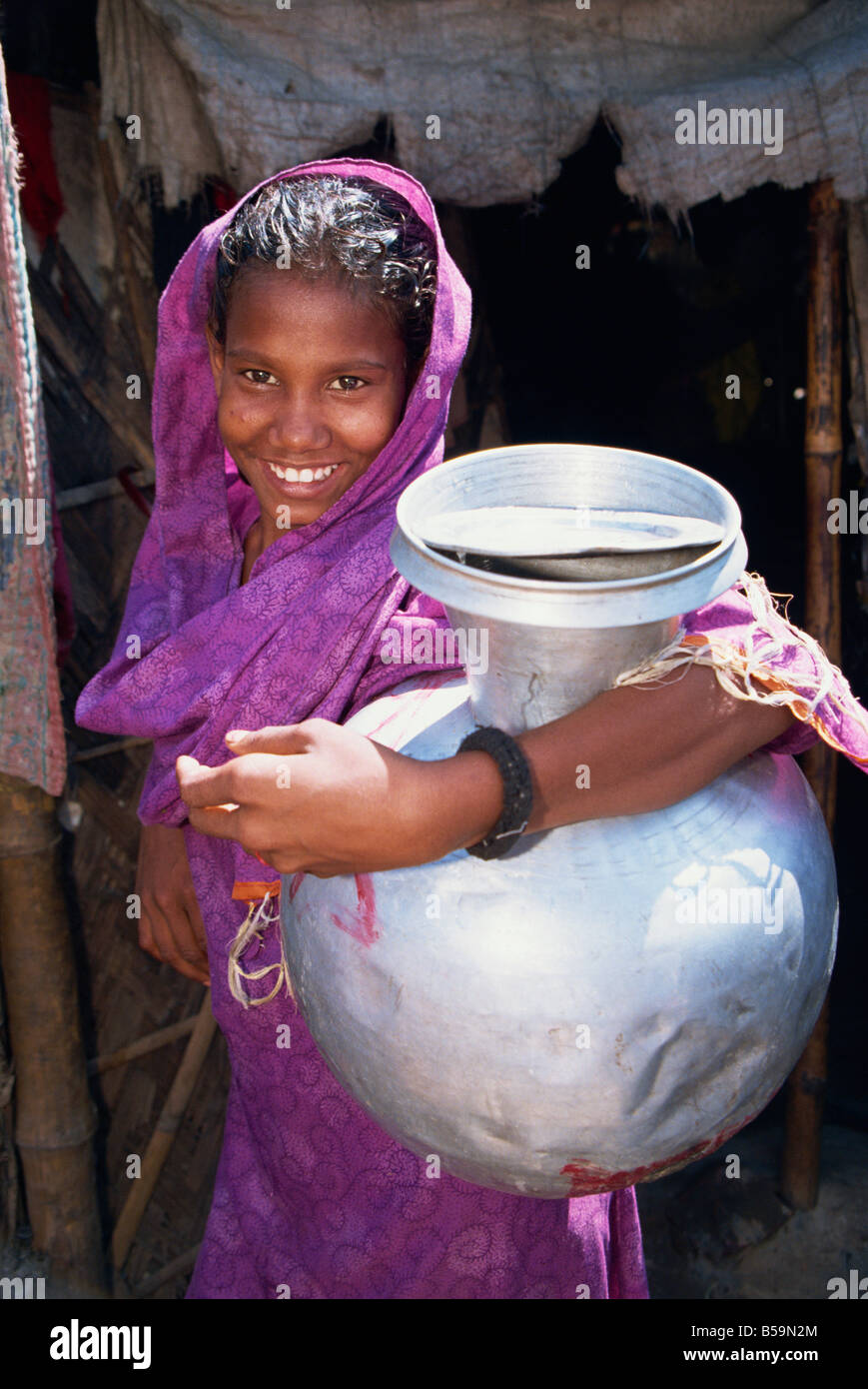 Portrait of a girl carrying a water pot in Bangladesh Asia L Taylor