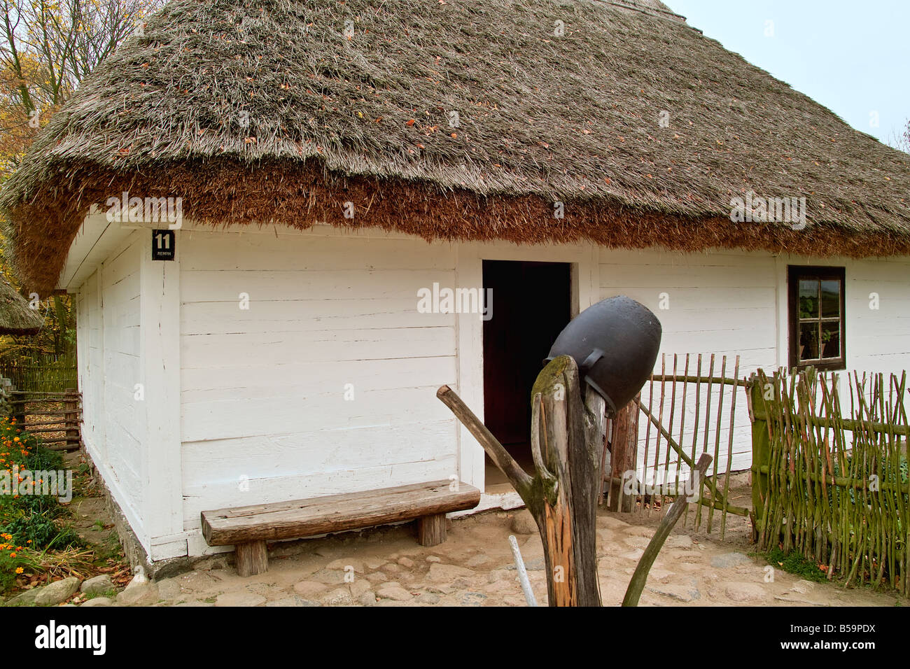 The turn of XIX and XX century thatched roof cottage Stock Photo