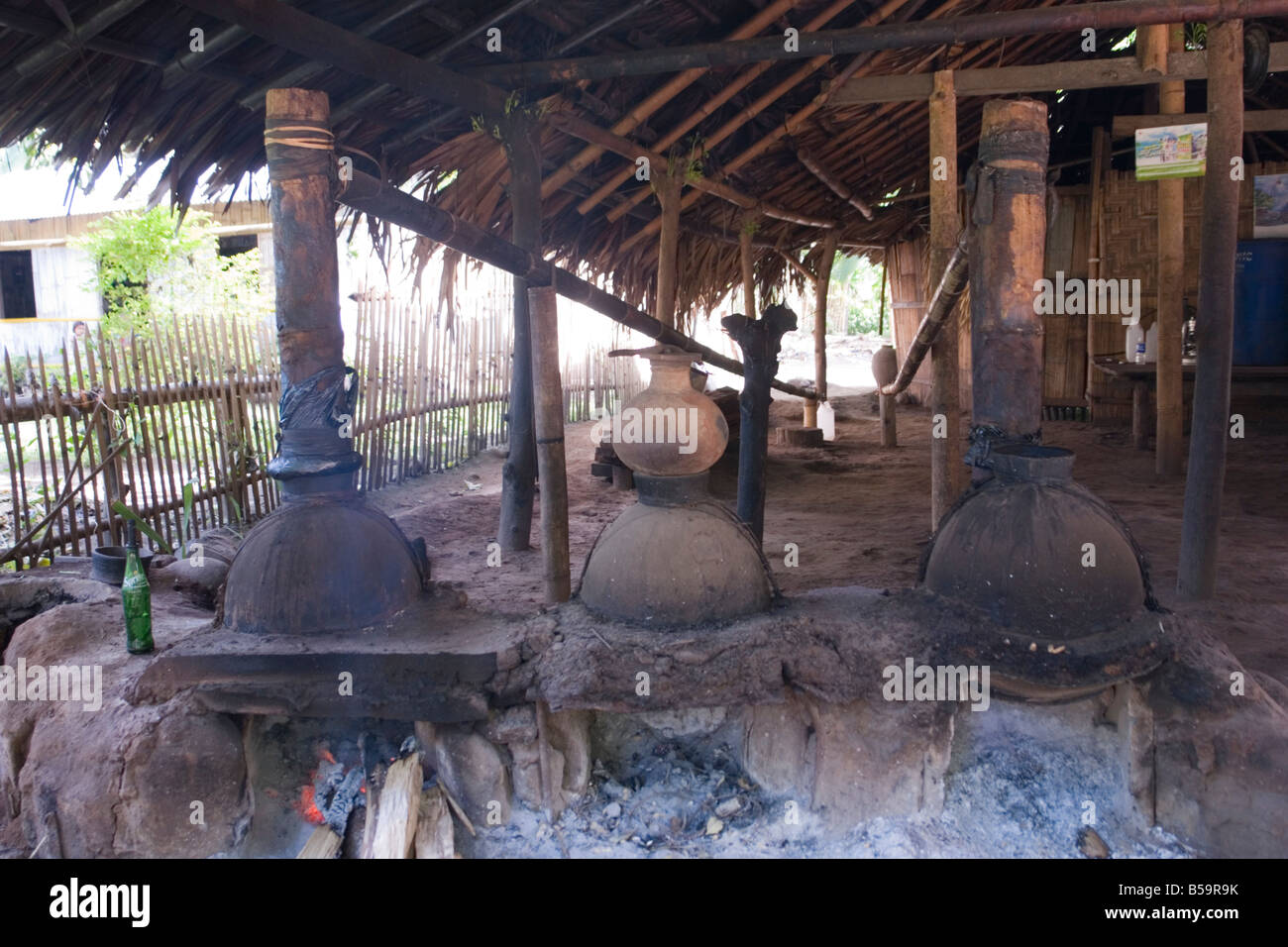 A cottage industry in Flores: the Arak processing (Indonesia). Une distillerie artisanale d' Arak à Florès (Indonésie). Stock Photo