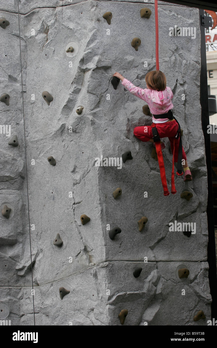 Kid playing on rock climbing wall at science museum festival,editorial-use only Stock Photo
