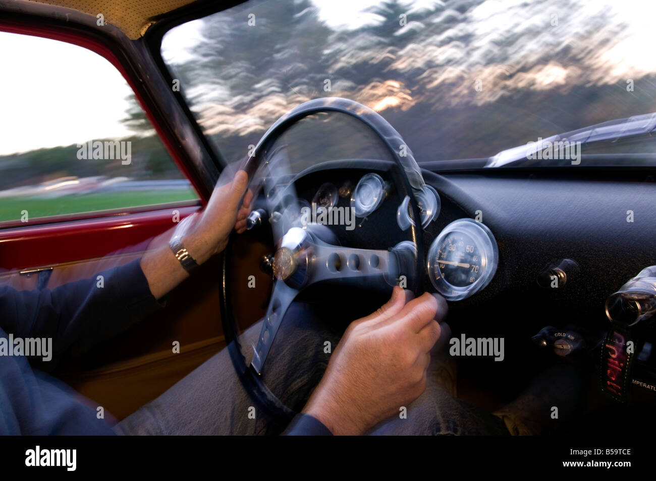 Driving a classic car at speed Stock Photo