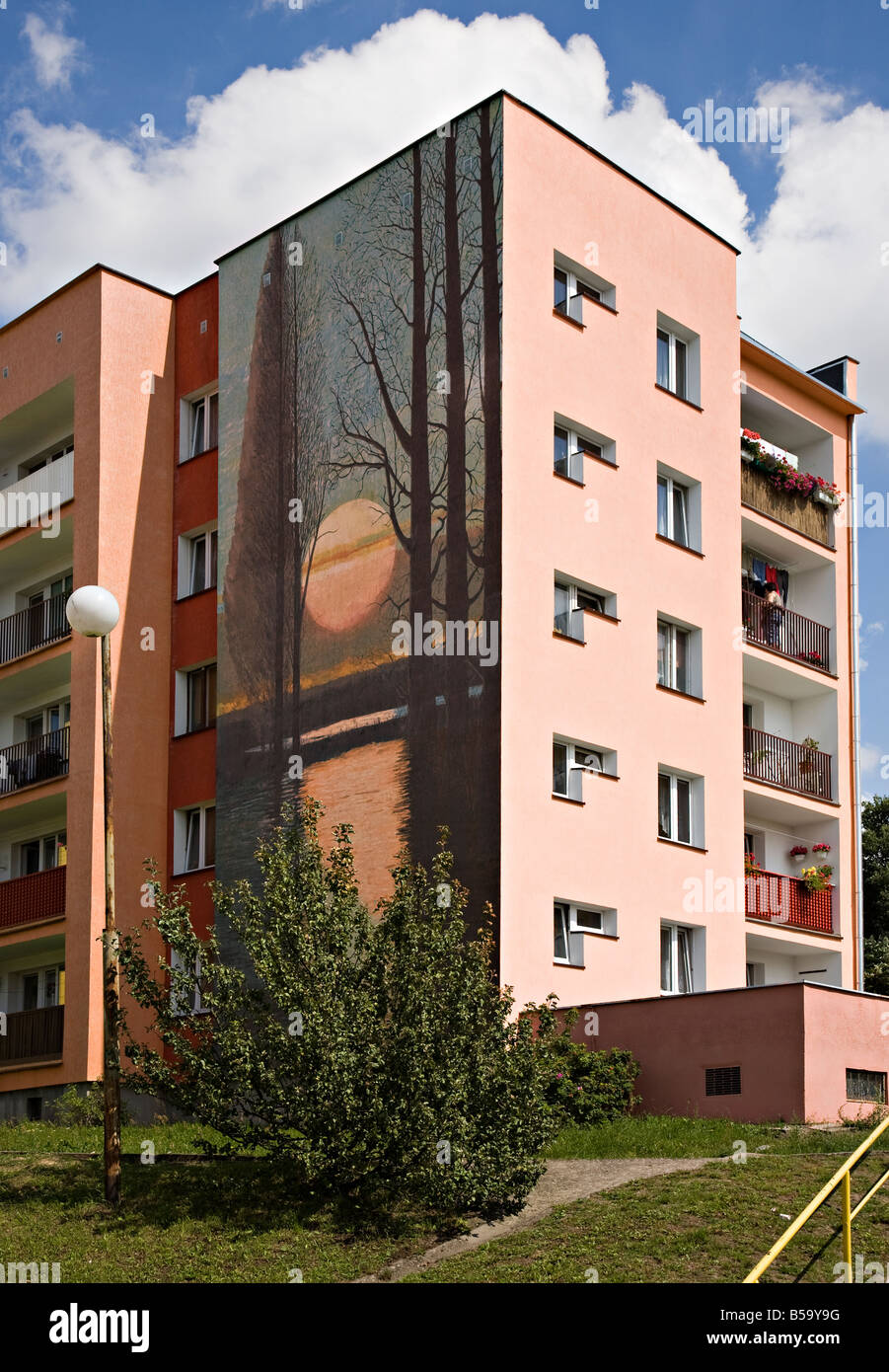 Brightly painted block of flats with mural on housing estate Miastko