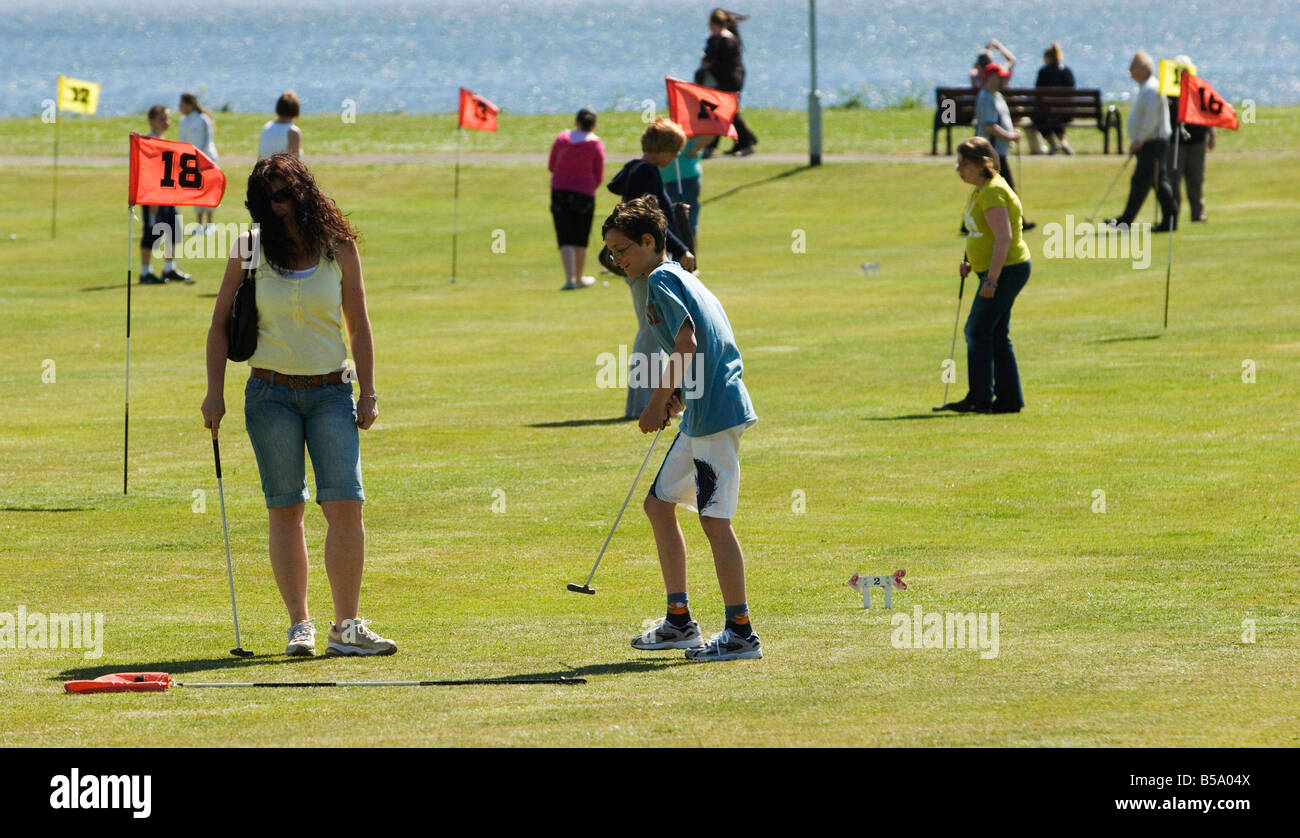 A family on Largs putting green on a summers day Stock Photo Alamy