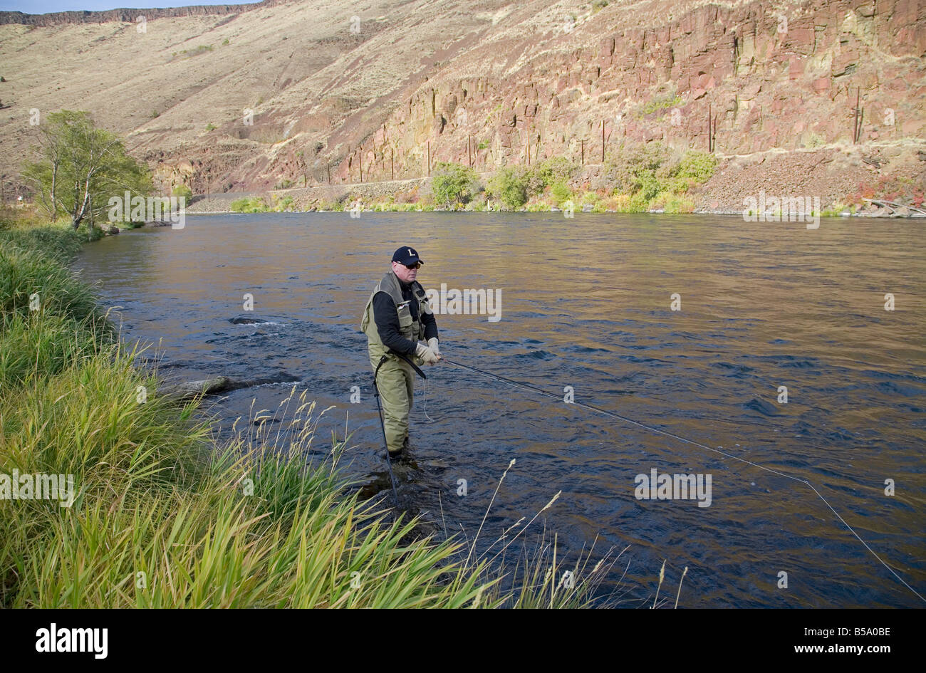 A fly fisherman casts flies for steelhead trout on the Deschutes River