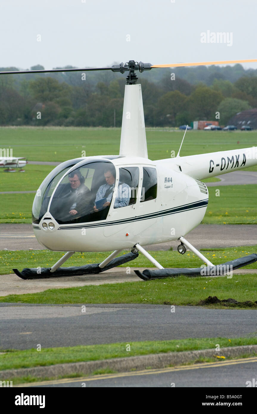 Pilot and Instructor in a Robinson R 44 Clipper 11 Helicopter Redhill Aerodrome Surrey Small 2 man Helicopters Stock Photo
