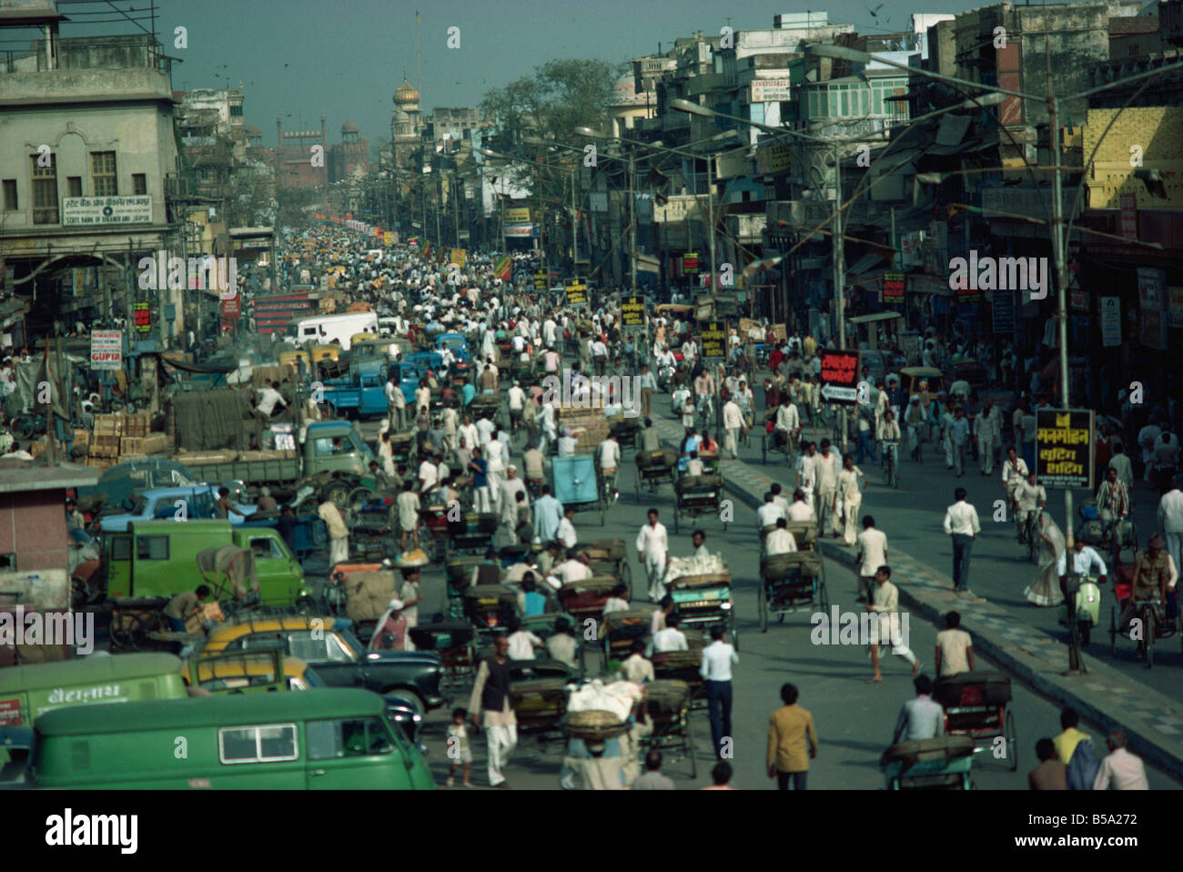 Busy street in Old Delhi looking towards Red Fort in distance Delhi India Asia Stock Photo