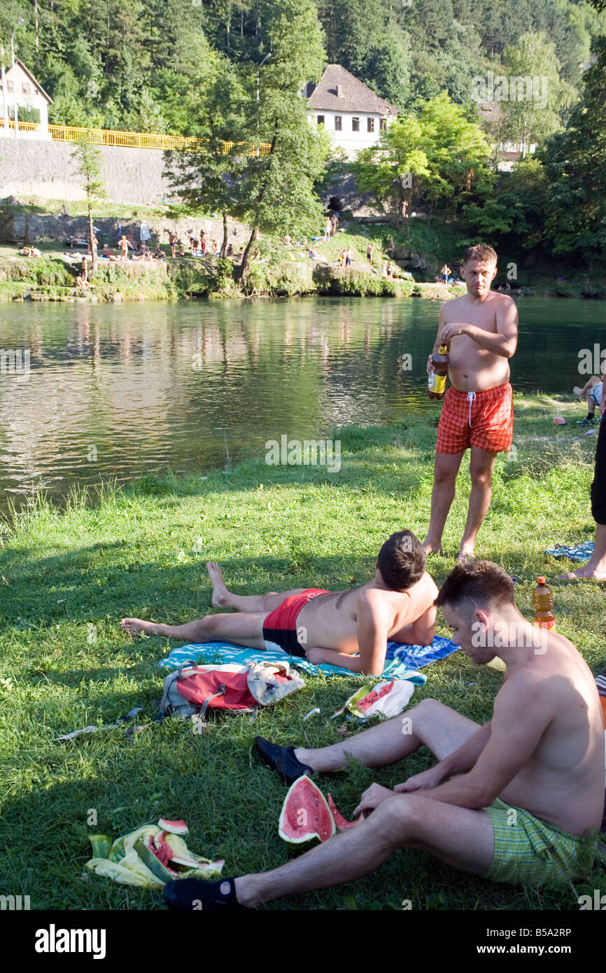 Boys have picnic on the bank of Vrbas river on hot summer day Banja Luka Republic of Srpska Bosnia and Herzegovina Stock Photo