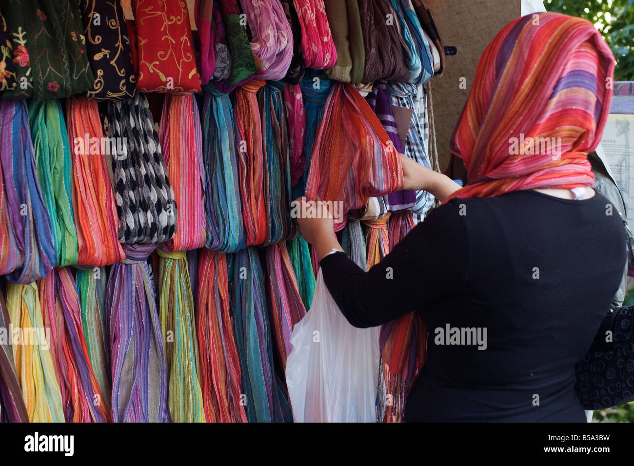 Immigrant women check Kerchiefs at a marketplace. Stock Photo