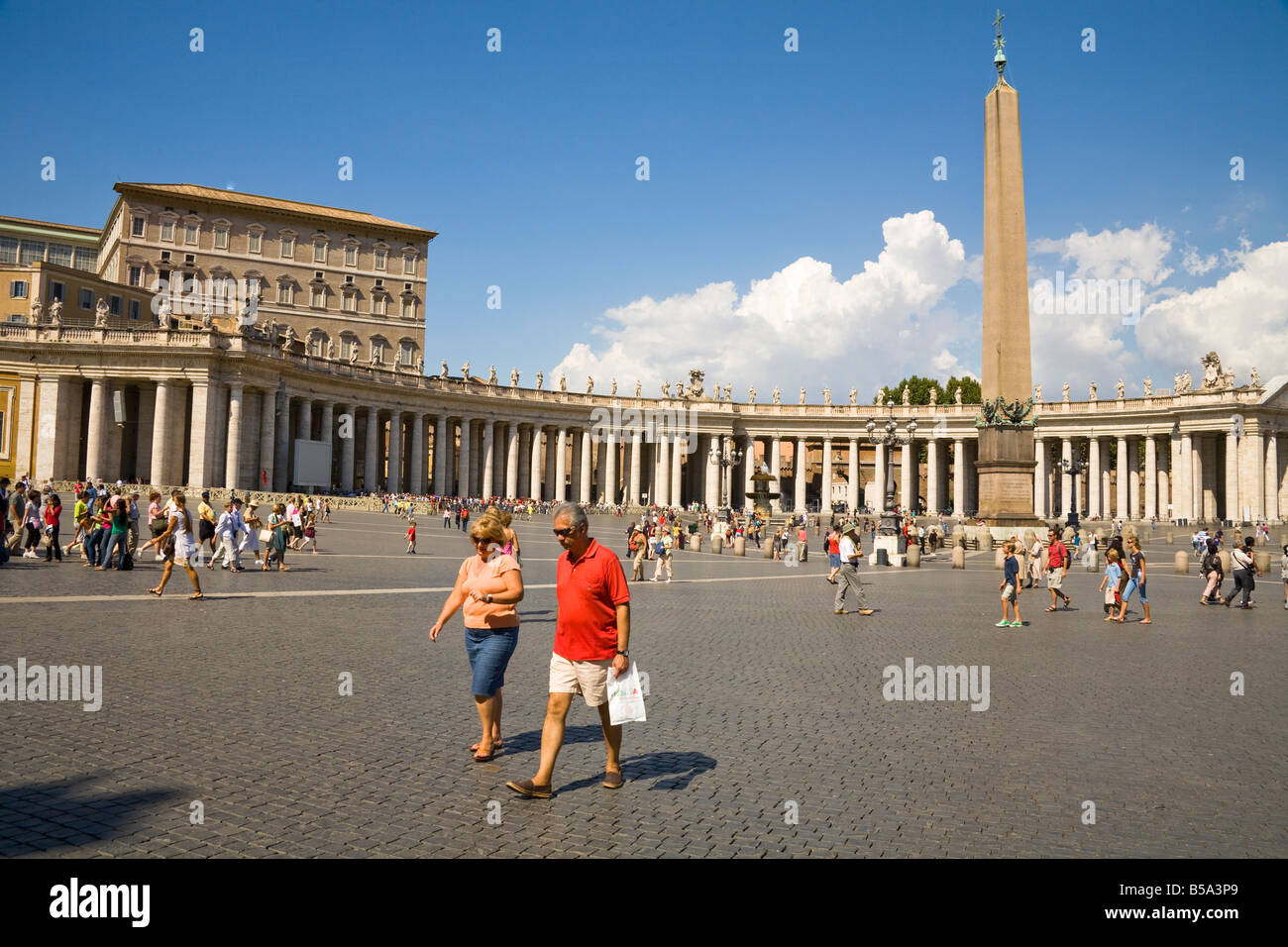Tourists, obelisk and colonnade, Saint Peter’s Square, Piazza San Pietro, Vatican City, Rome, Italy Stock Photo
