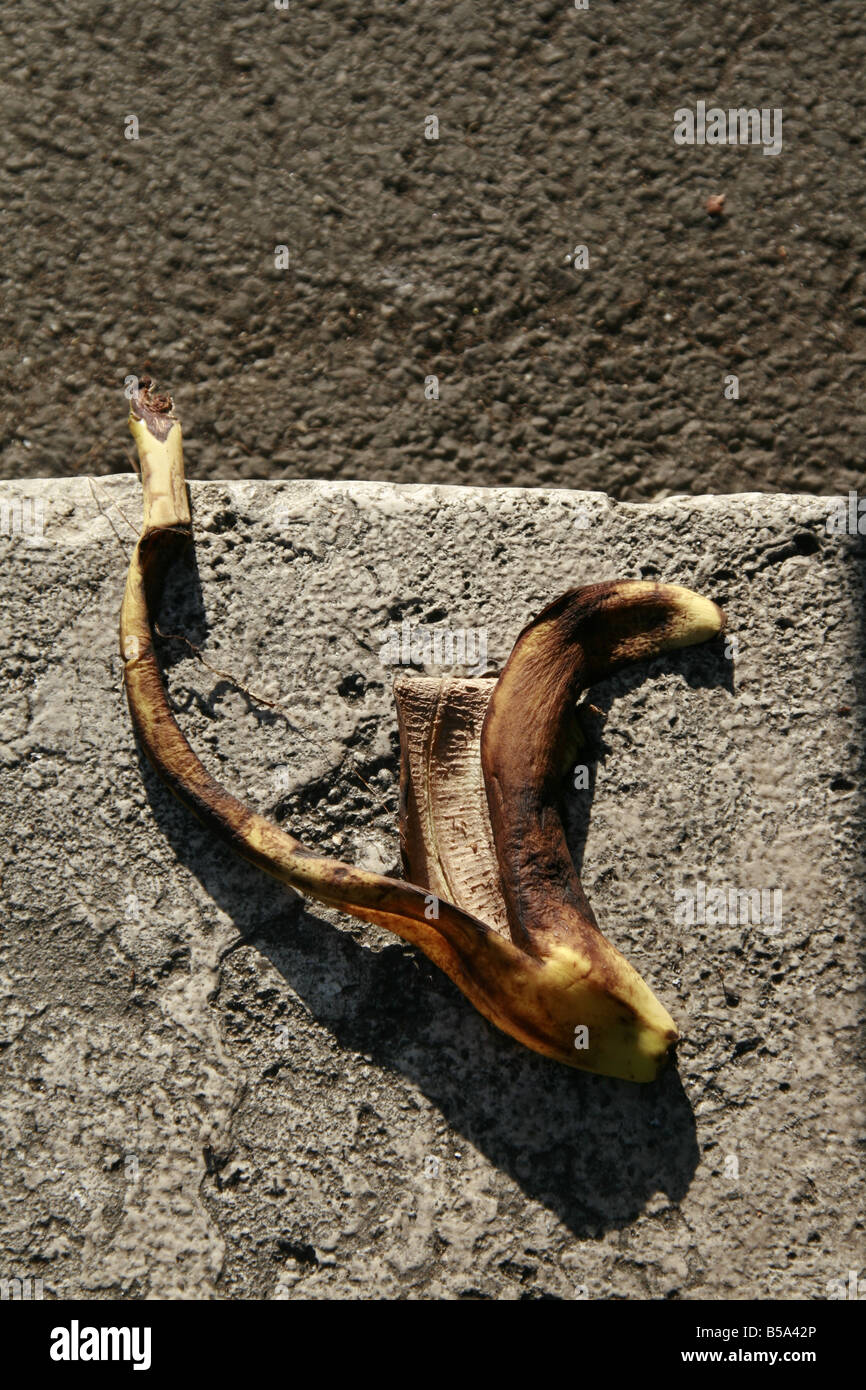 Image showcasing one banana peel left thrown on street in town Stock Photo - Alamy
