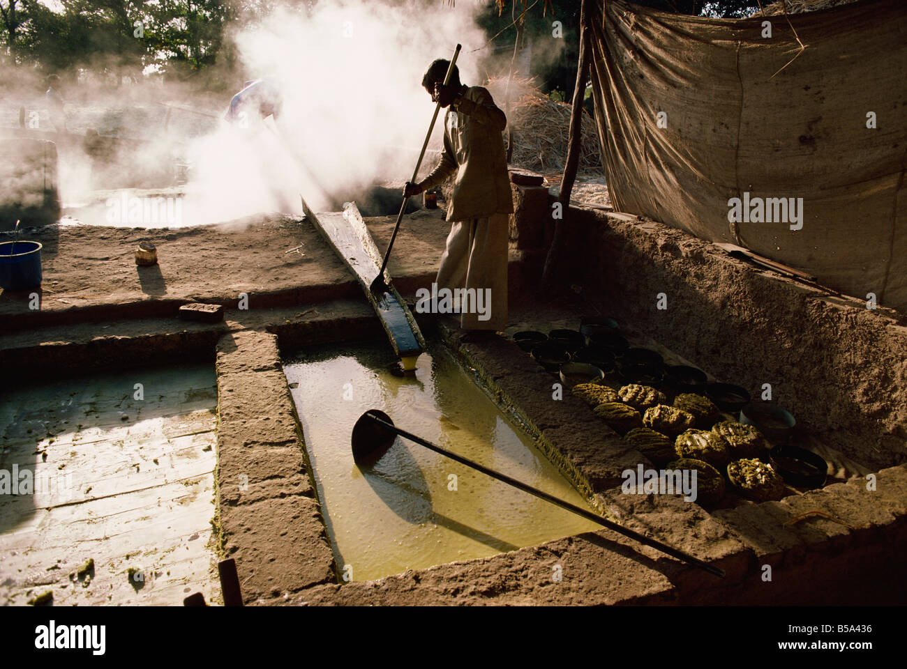Cane juice being boiled into sugar after sugar cane harvest Gujarat