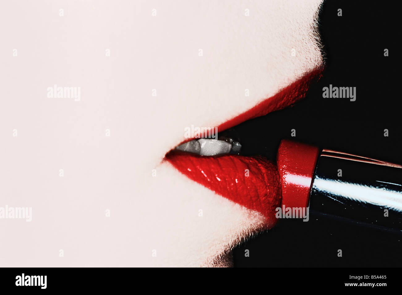 Woman Putting On Lipstick Stock Photo - Alamy