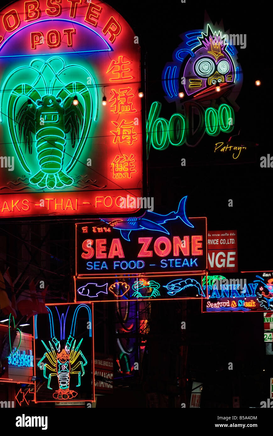Neon signs outside seafood restaurants in the walking street a section of Beach road in South Pattaya Stock Photo