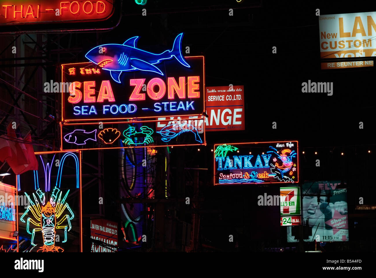 Neon signs outside seafood restaurants in the walking street a section of Beach road in South Pattaya Stock Photo