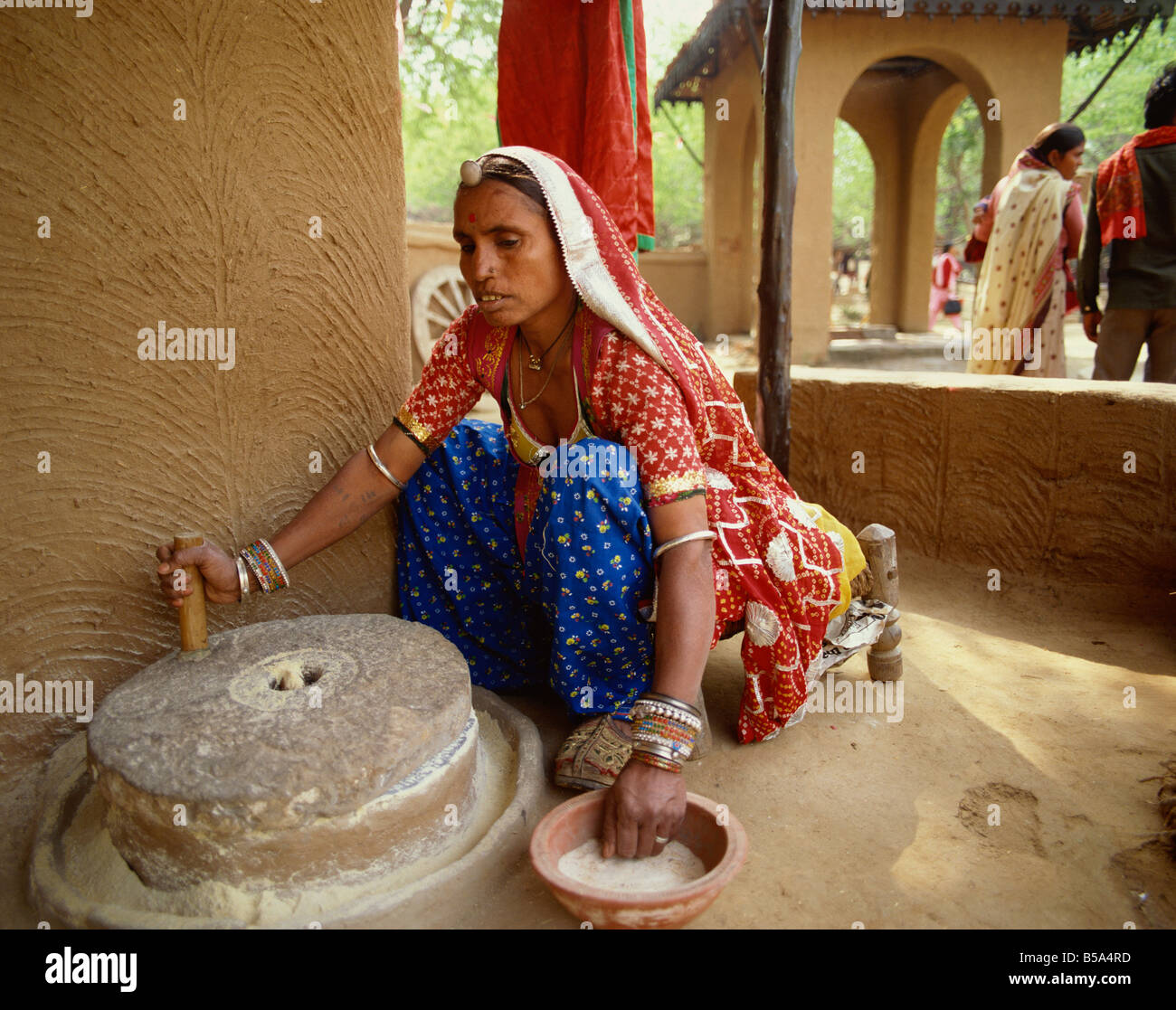 Grindstone woman flour hires stock photography and images Alamy