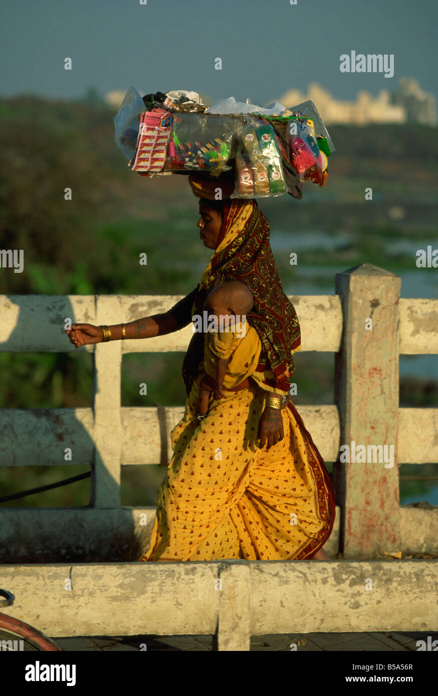 Indian woman carrying baby on hi-res stock photography and images - Alamy