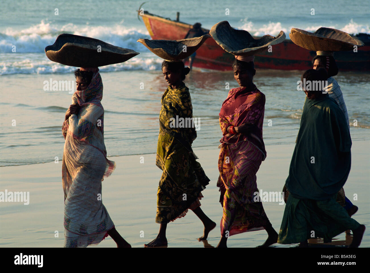 Women using turtle shells to carry fish on their heads Puri Orissa State India J Bright Stock Photo