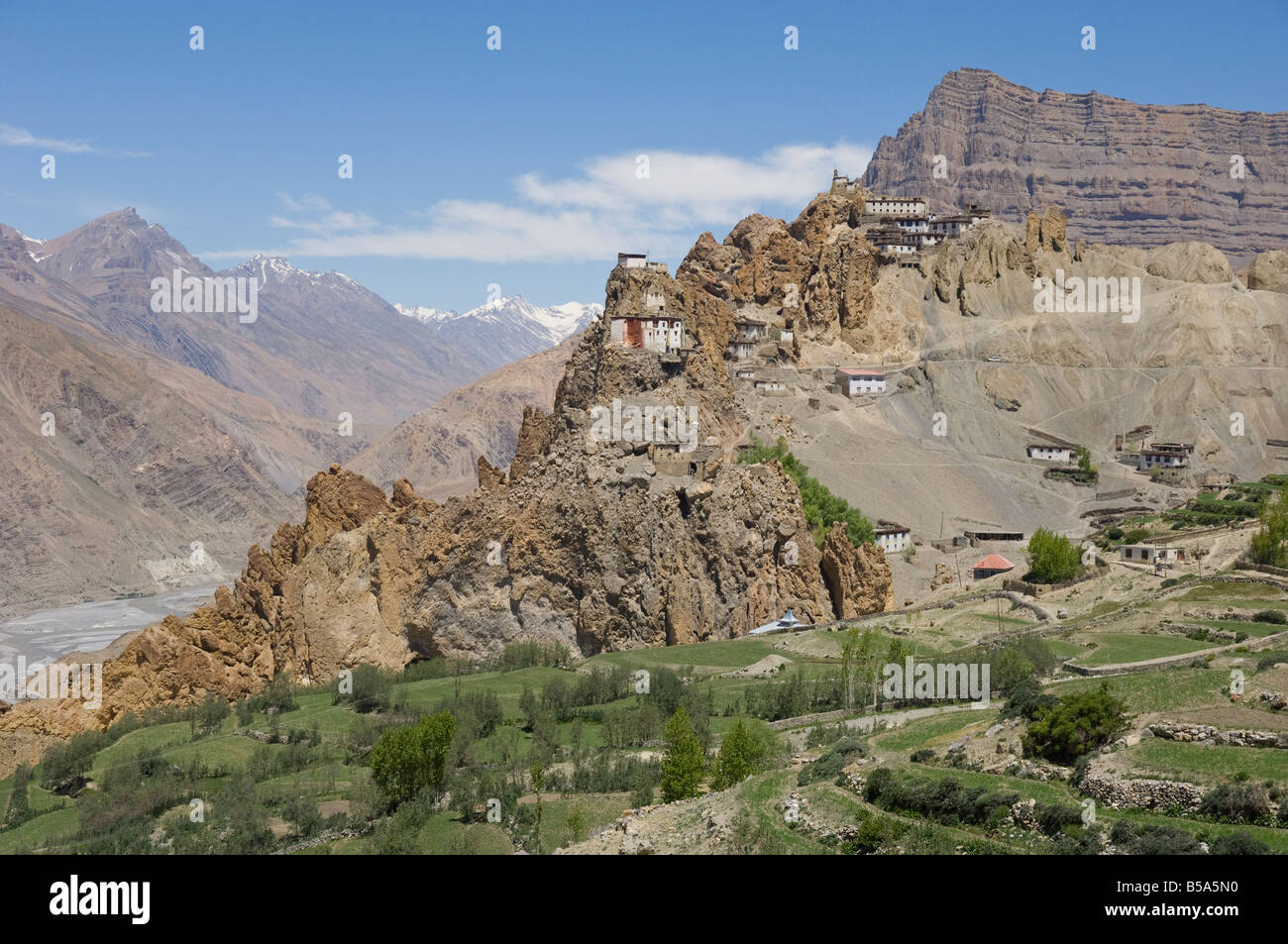 View from afar of Dhankar monastery, and cliff and snowy mountains beyond, Spiti, Himachal Pradesh, India Stock Photo