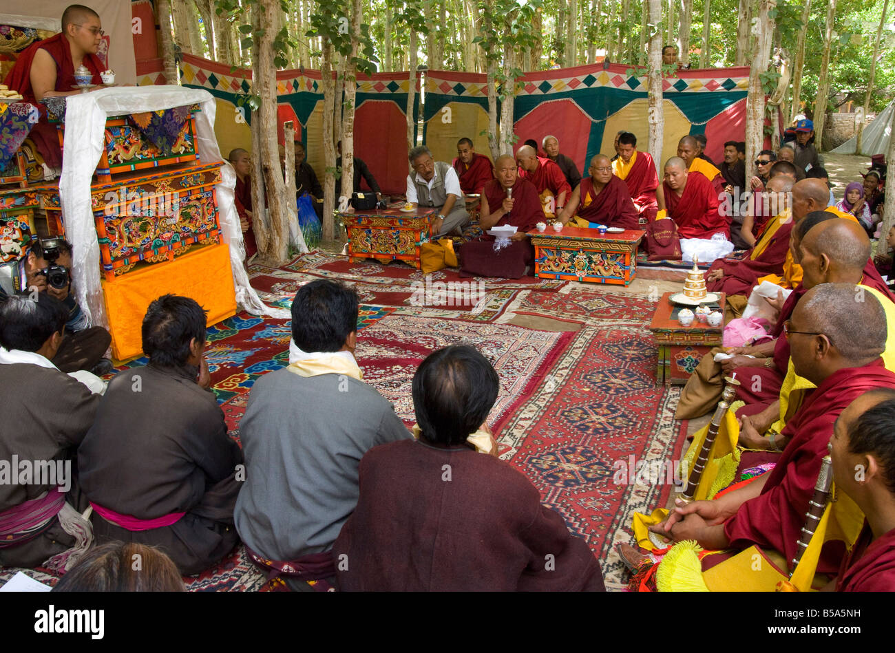 Local Lama adressing an assembly of monks and the public during official visit, Alchi, Ladakh, India Stock Photo