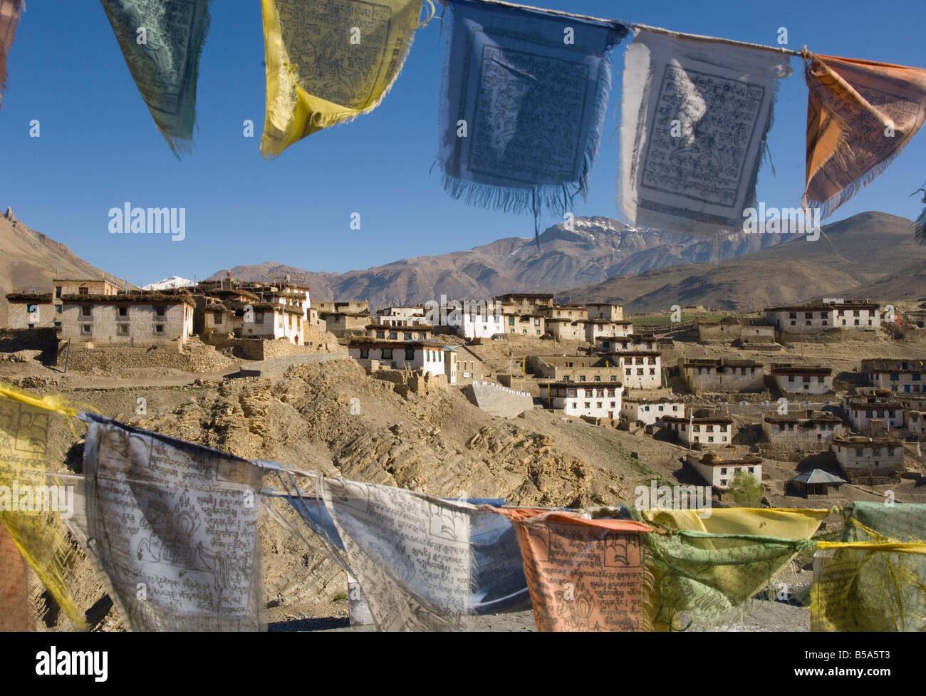 View of the village of Kibber, 4205 m, through traditional prayer flags, Spiti, Himachal Pradesh, India Stock Photo