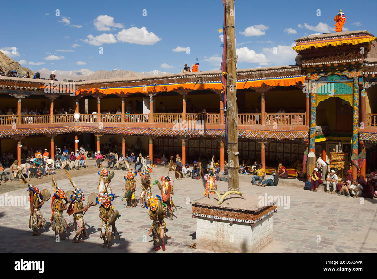 View from above of monastery courtyard with monks in traditional costumes dancing, Hemis Festival, Hemis, Ladakh, India Stock Photo