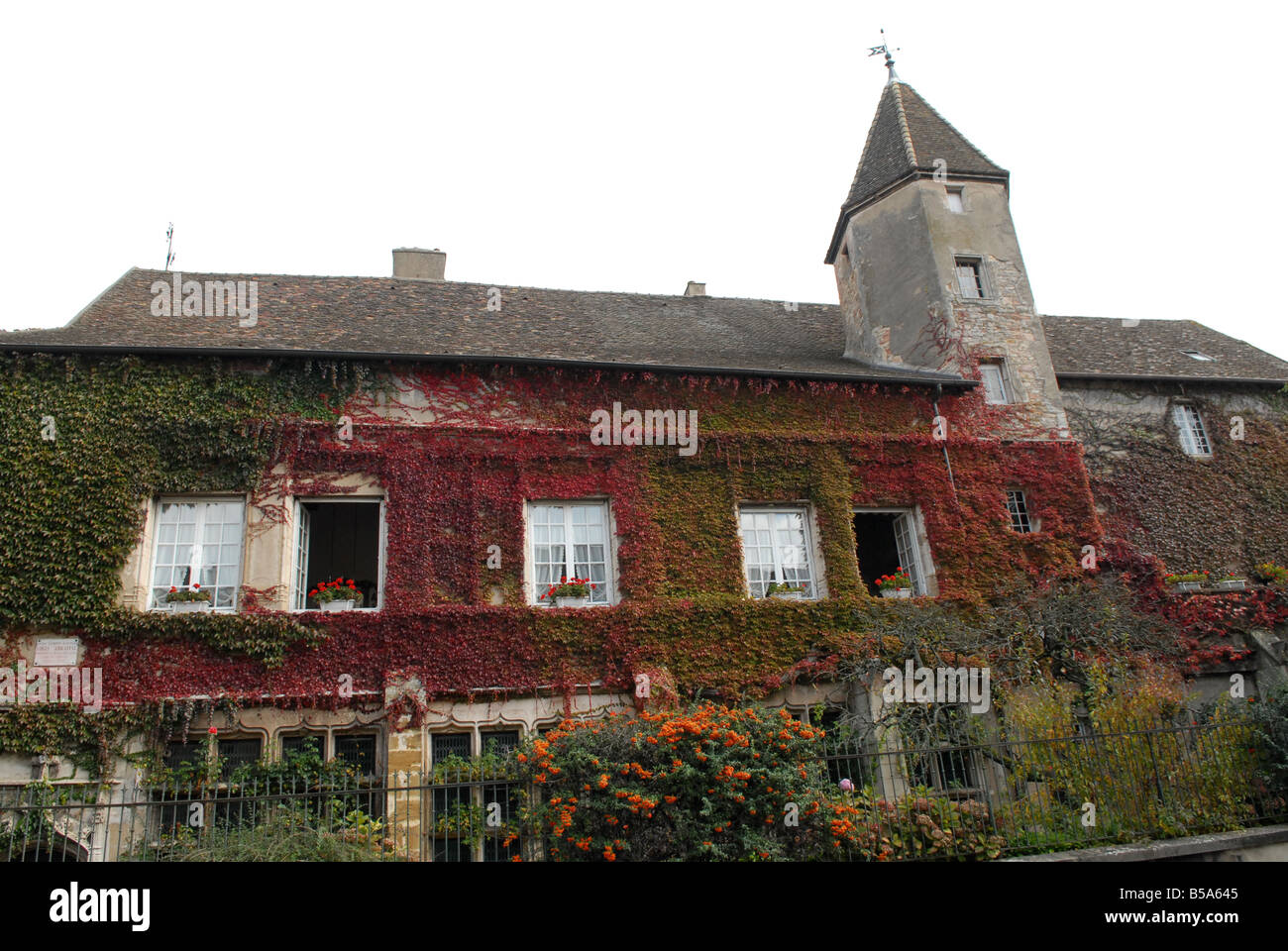 A visitor walking through the tunnel entrance to Chateau de Brancion &  historic village in Saone et Loire, Burgundy, France Stock Photo - Alamy