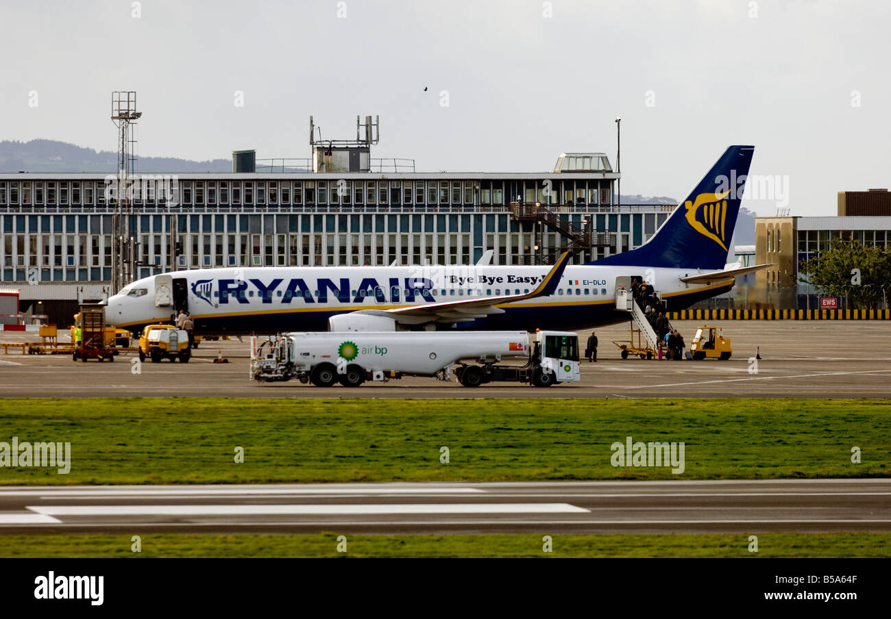 A Ryanair plane is boarded by passengers at Glasgow Prestwick International Airport, Ayrshire, Scotland. Stock Photo