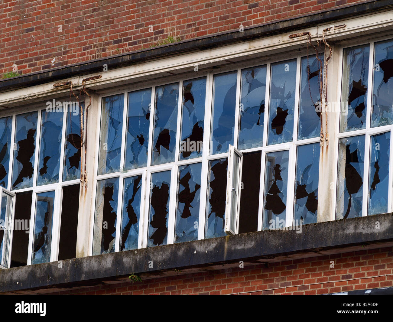 Broken windows on an old brick walled building Stock Photo
