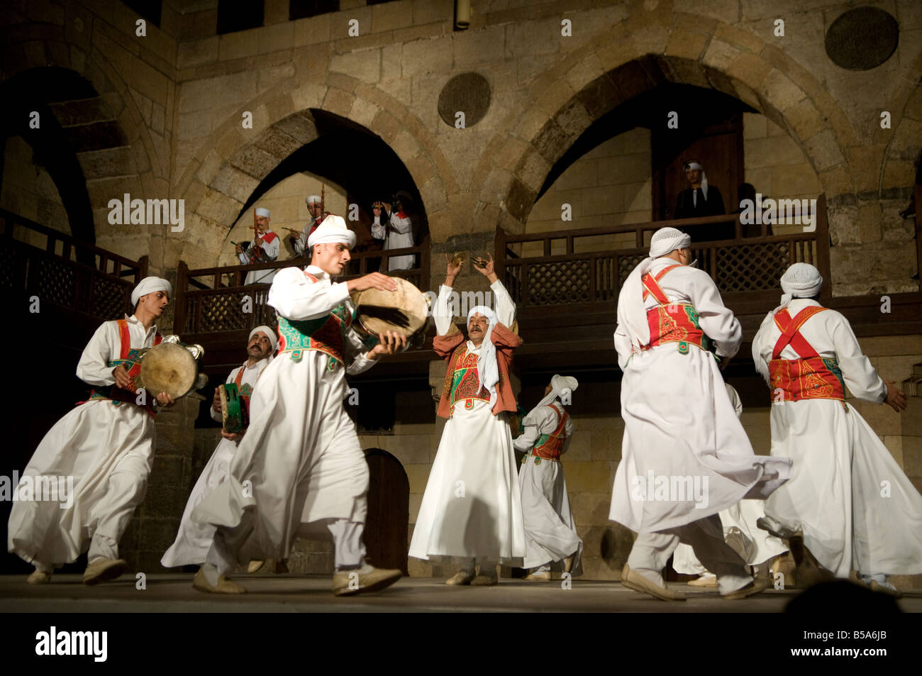 Dervish or Darvish performance of al tannoura Egyptian heritage dance troupe at the Wekalet el Ghouri Arts Center in Old Cairo Egypt Stock Photo