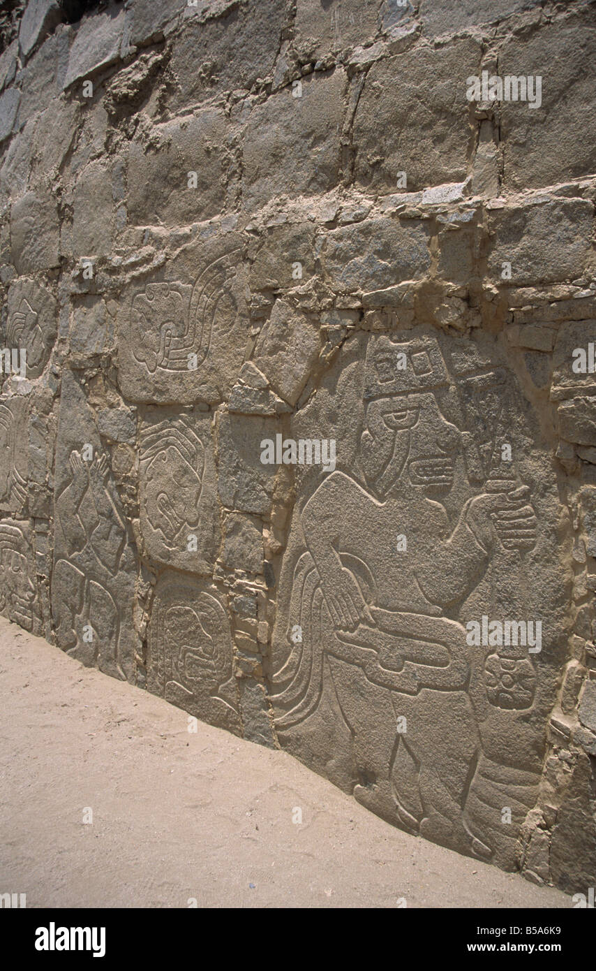 Carved relief of stone warrior with trophy heads behind in pre-Chavin site of Cerro Sechín, Casma Valley, Peru Stock Photo