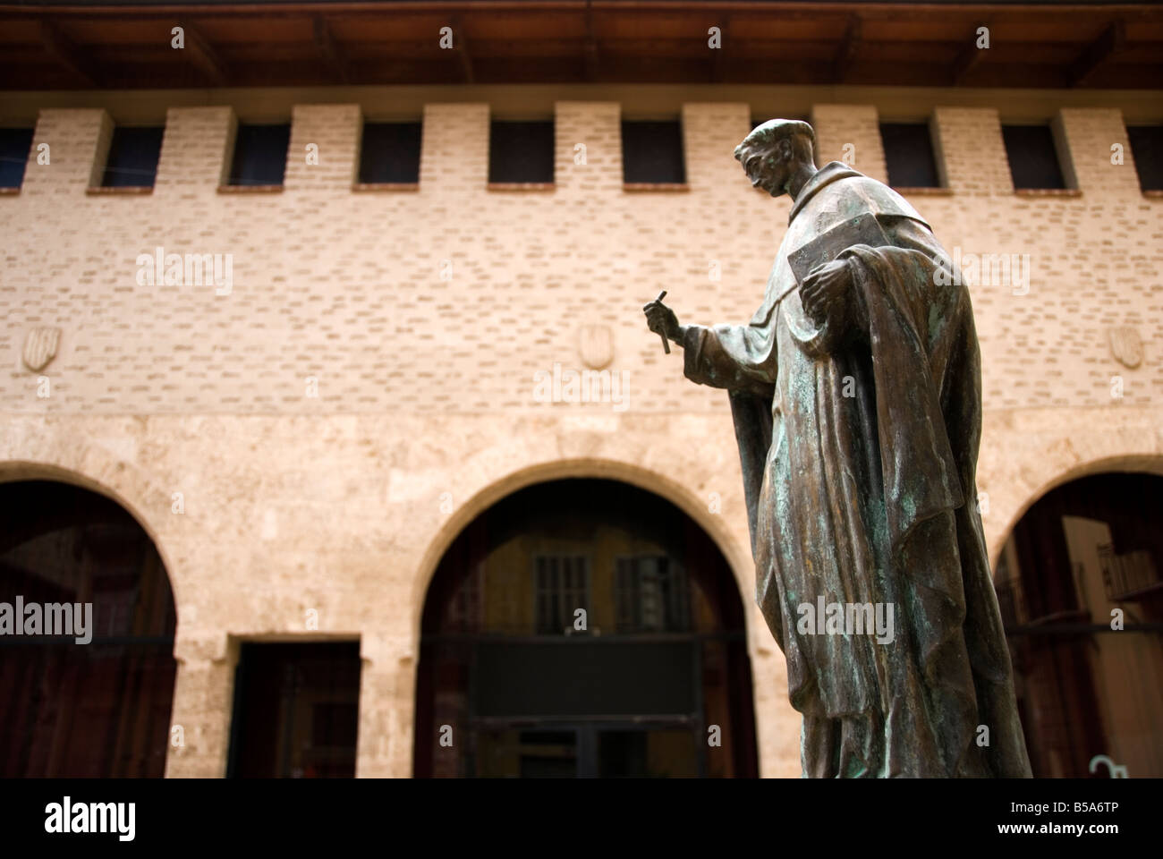 Bronze statue of a monk in front of the old city granary Almudin which ...