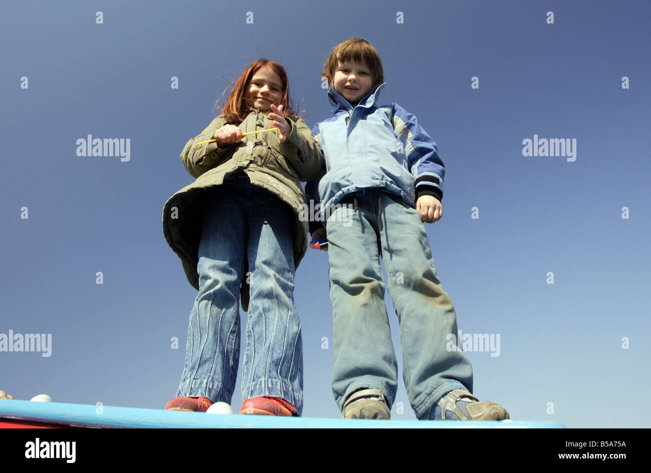A boy and a girl looking down at the camera Stock Photo - Alamy