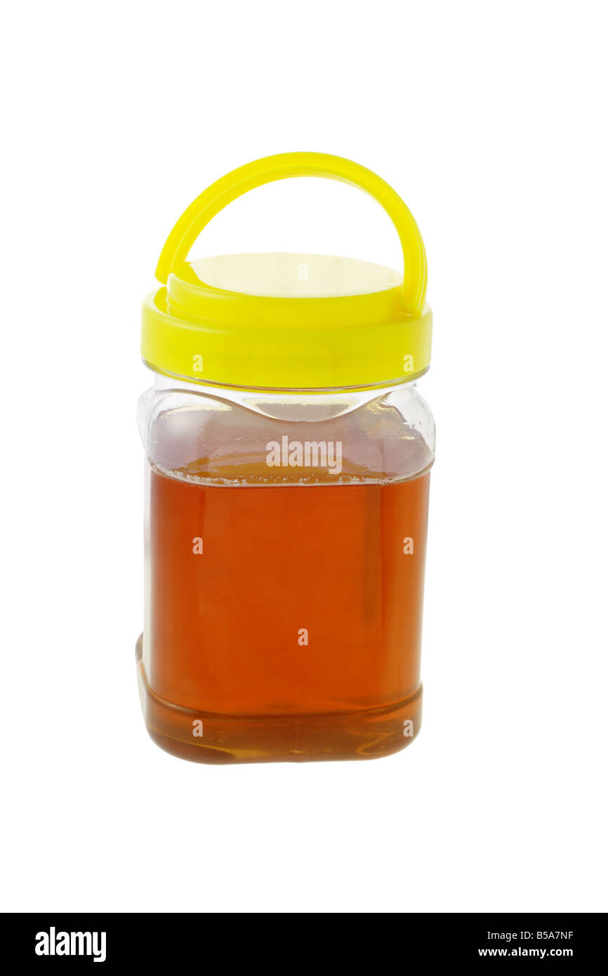 Jar of honey with lid on white background Stock Photo Alamy