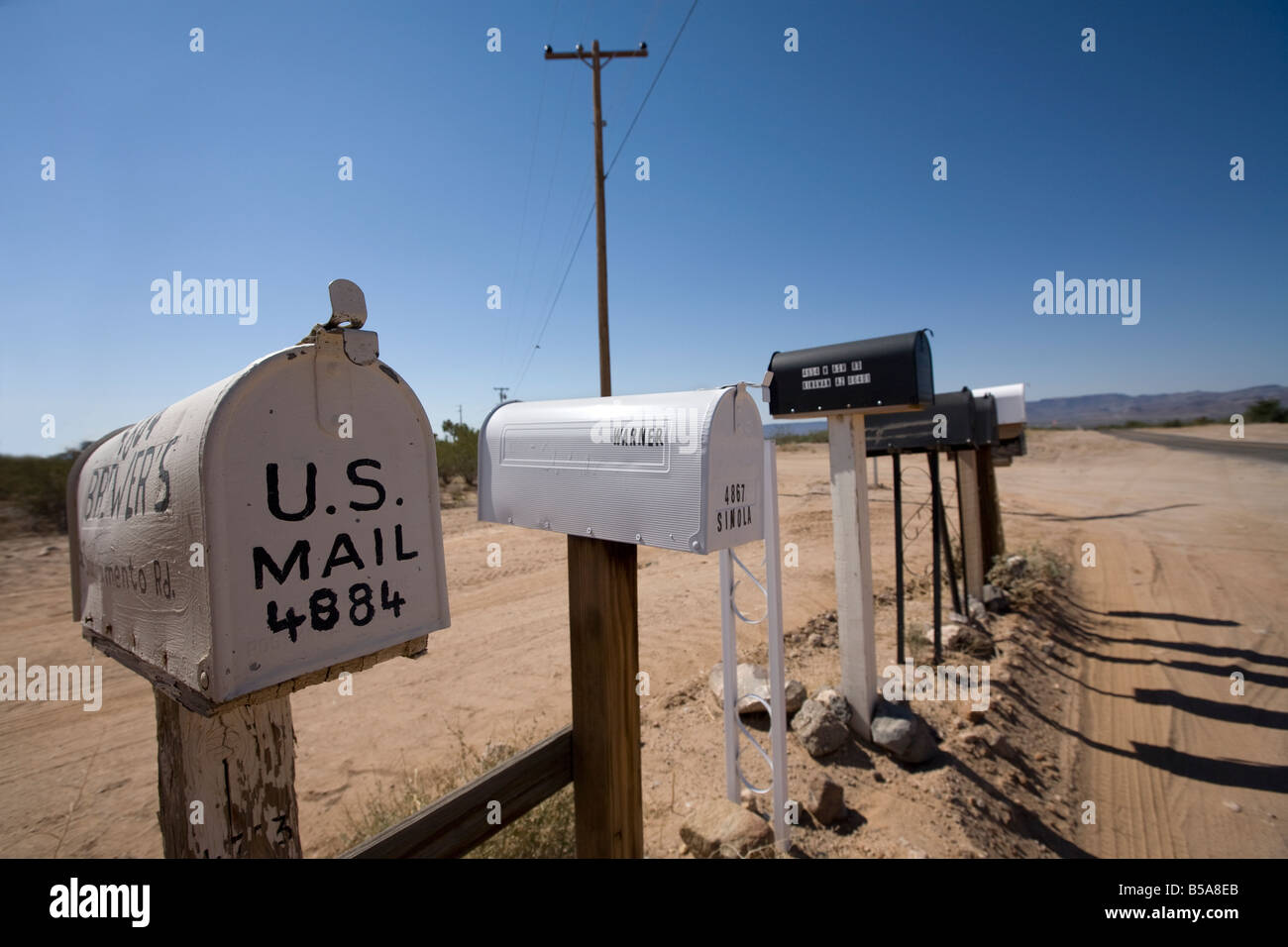 Row of US mailboxes on the roadside. Stock Photo