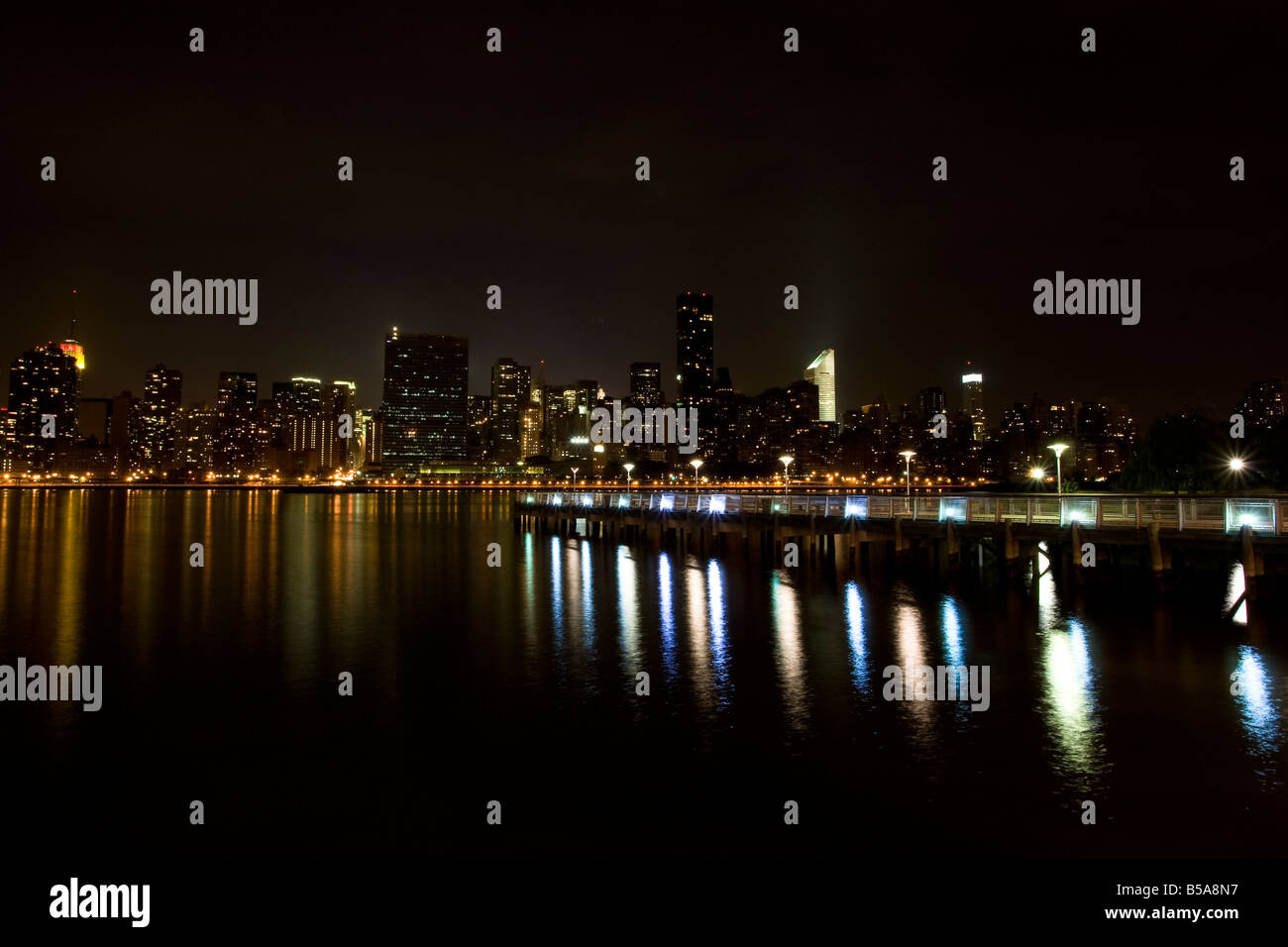 A pier in Long Island City (Queens) with the New York City (Manhattan) skyline in the background taken from Queens at night. Stock Photo