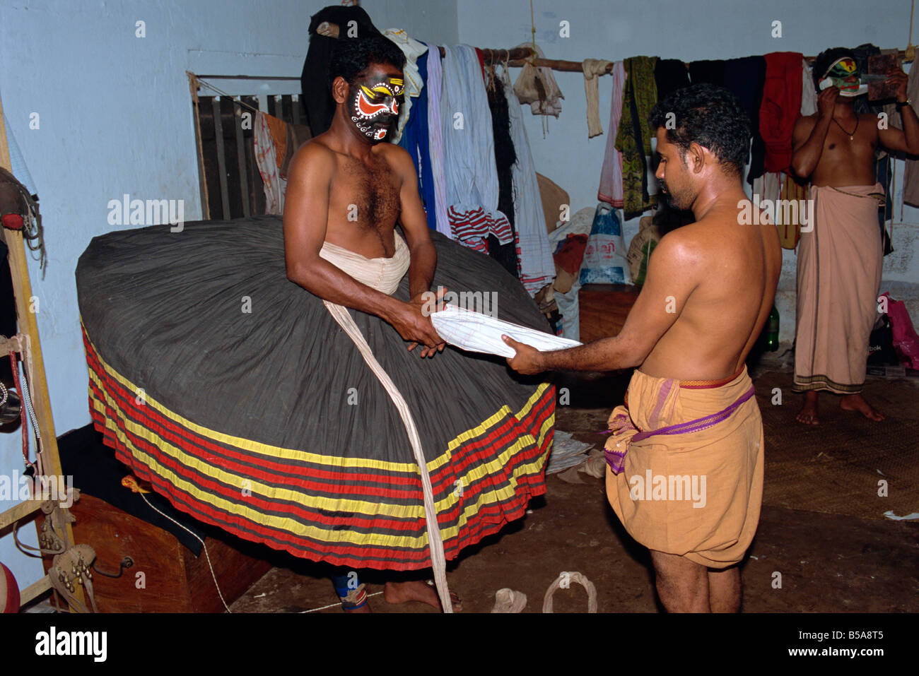 Kathakali dancer dressing in costume, Kerala state, India Stock Photo