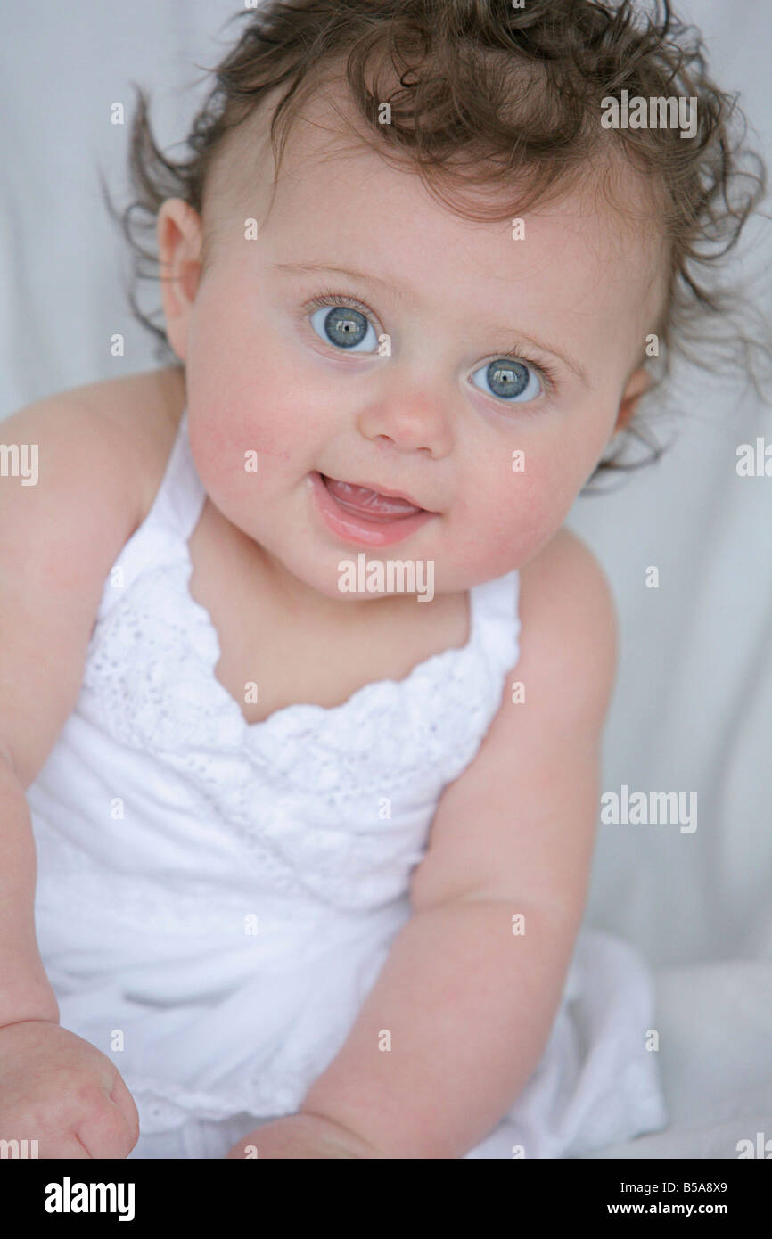 Baby girl in white dress Stock Photo Alamy