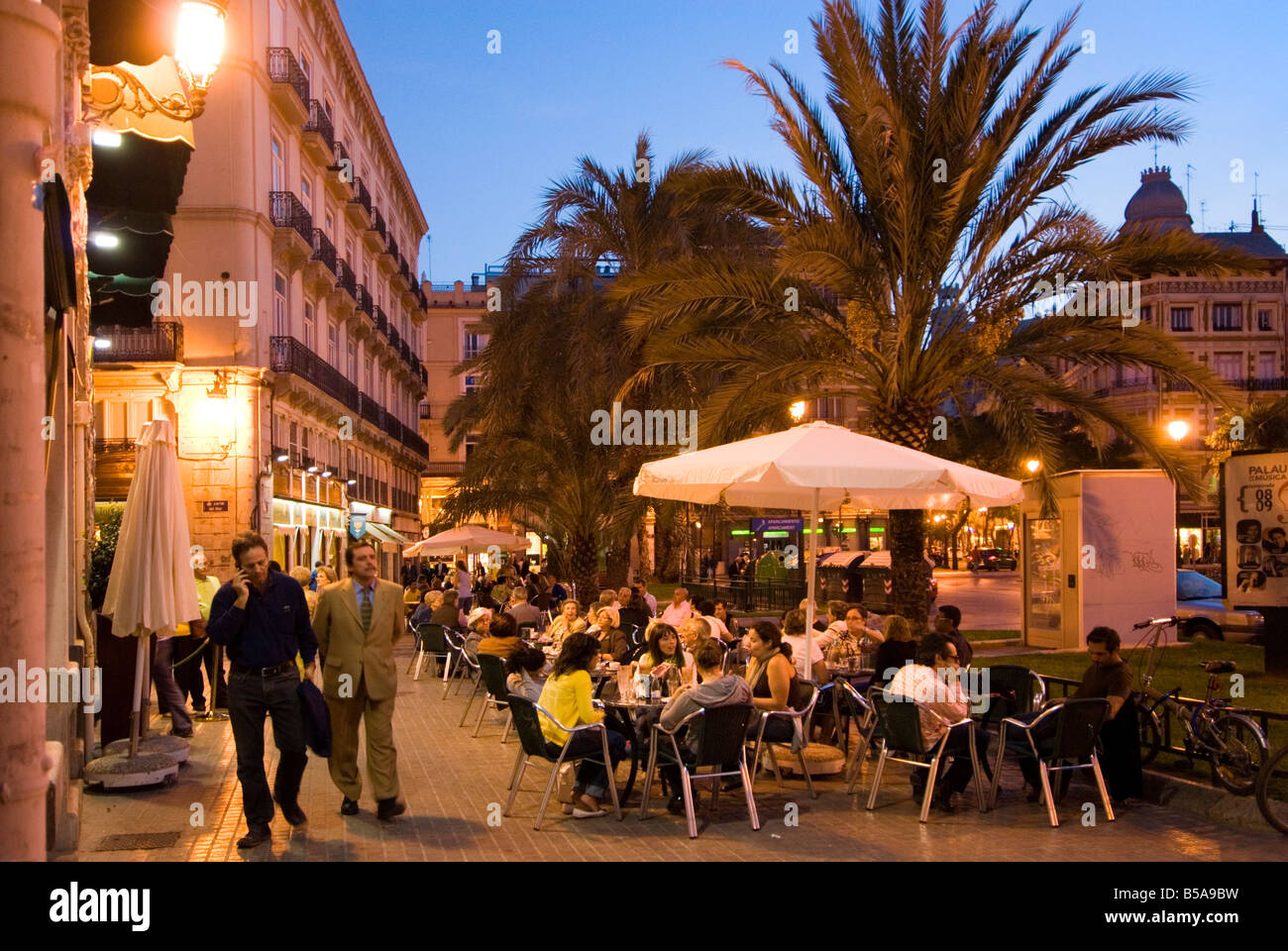People Sitting Outside A Busy Bar On Plaza De La Reina In The