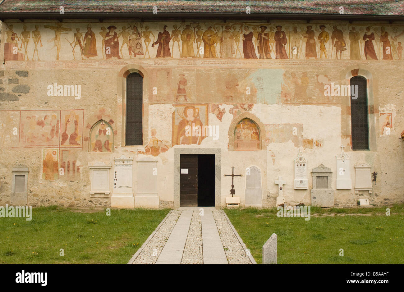 Extensive fresco treatment of the exterior of the ancient church of Chiesa di Vigilio, Pinzolo, Trentino-Alto Adige, Italy Stock Photo