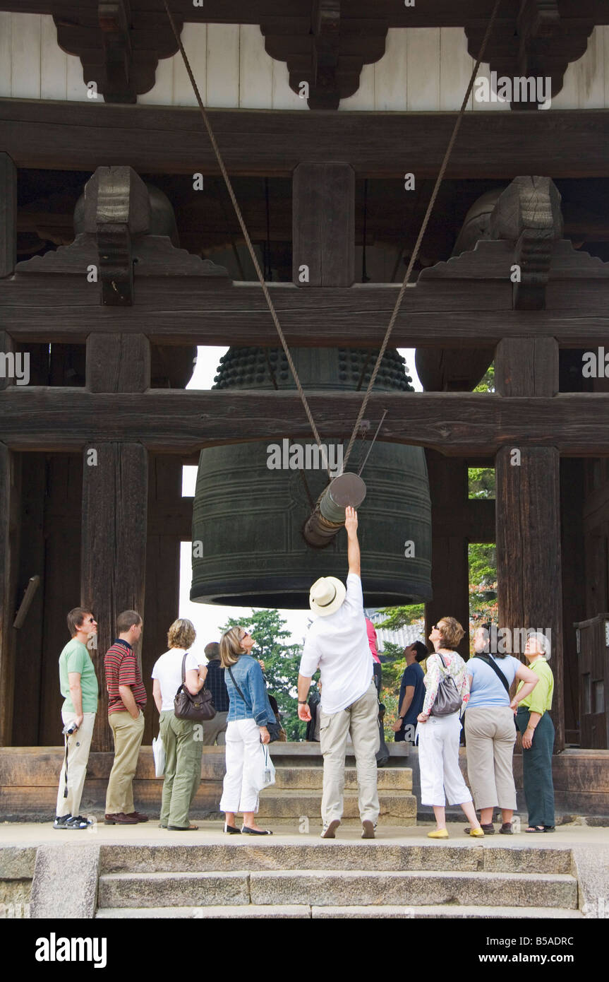 Tourists look at big cast iron bell, Todaiji Temple, Nara City, Nara Prefecture, Honshu Island, Japan Stock Photo