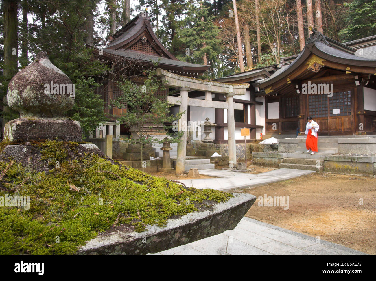 Courtyard with temple buildings and female priest, Sakurayama Nikko Kan temple, Takayama, Hida District, Honshu, Japan Stock Photo