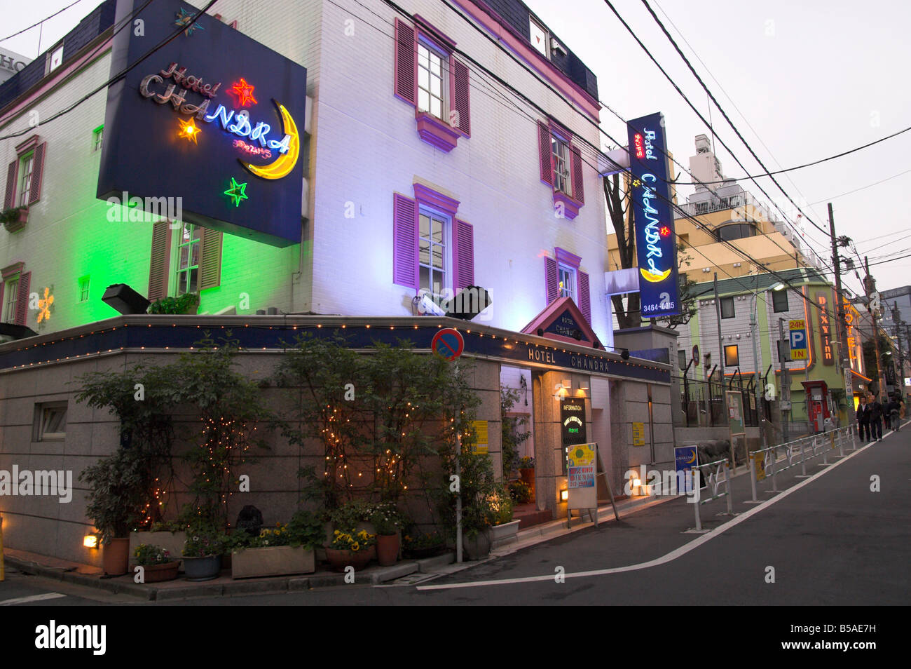 View at dusk of a street with row of love hotels, Dogenzaka, Shibuya, Tokyo, Honshu, Japan Stock Photo