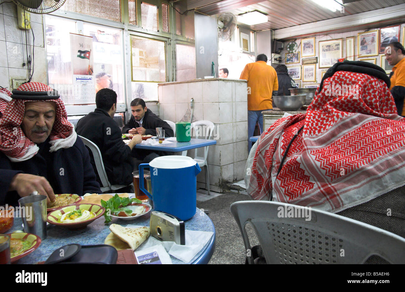 Men in keffiyeh eating traditional humus in Hashem restaurant, downtown